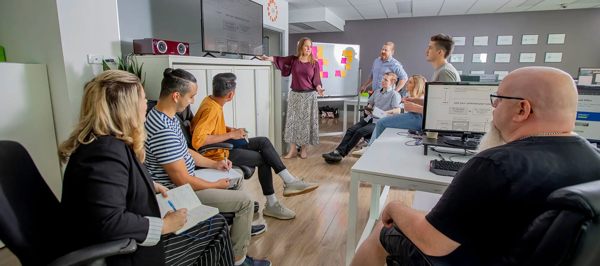 Click Click Media team hard at work around a table