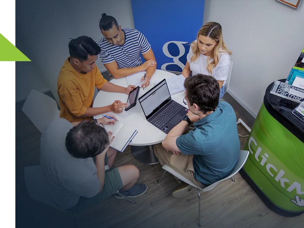 Click Click Media team hard at work around a table